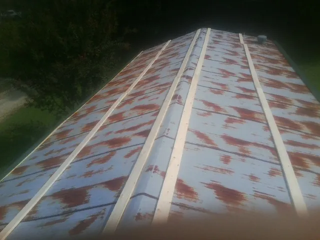 Rusted metal roof panels with new wood purlins before replacement — Storm Damage Roof Repair in Mohnton by Roofing Brothers
