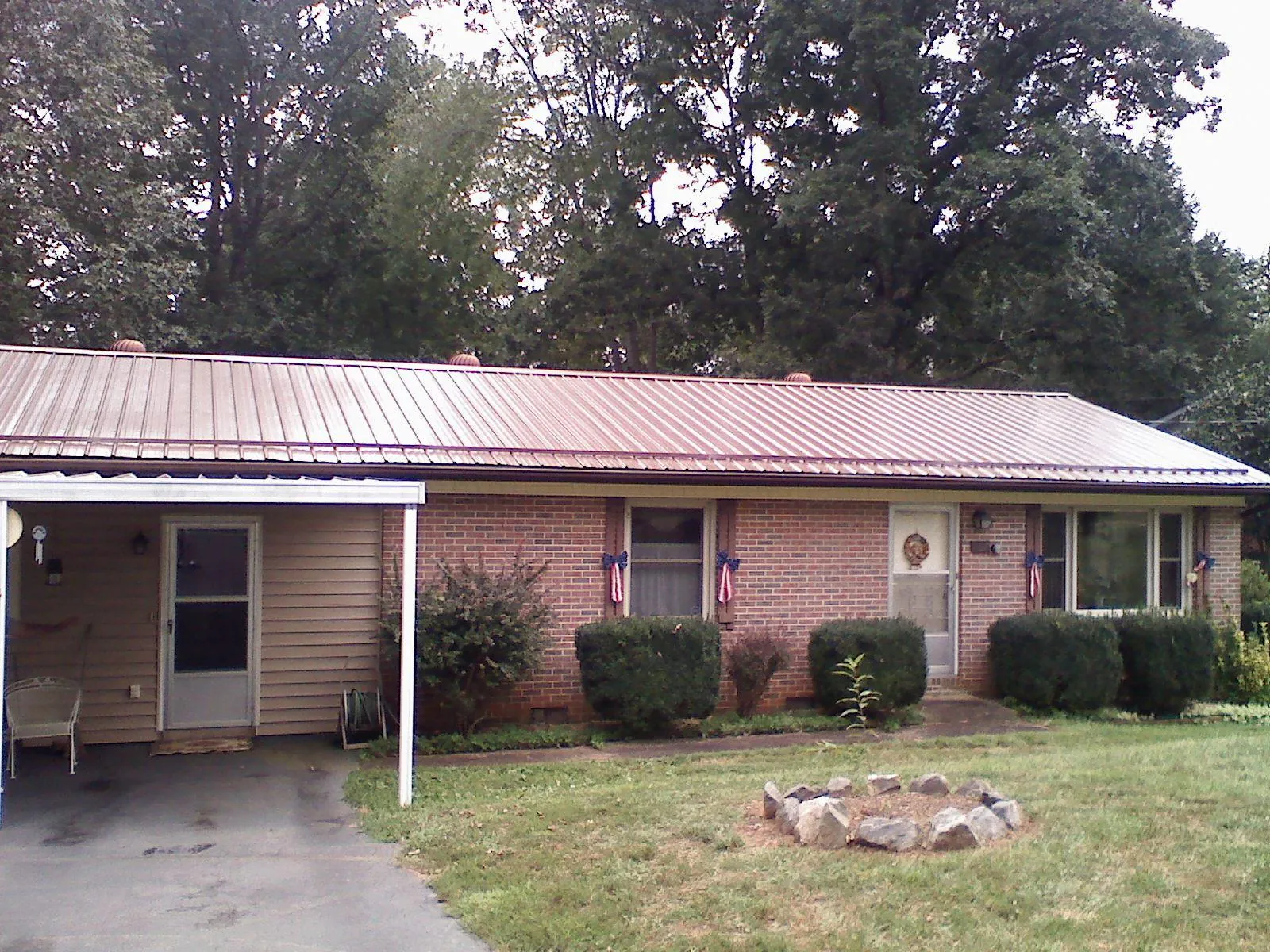 Bronze metal roof and carport on a brick ranch home — Roof Repair work by our crew in Mohnton