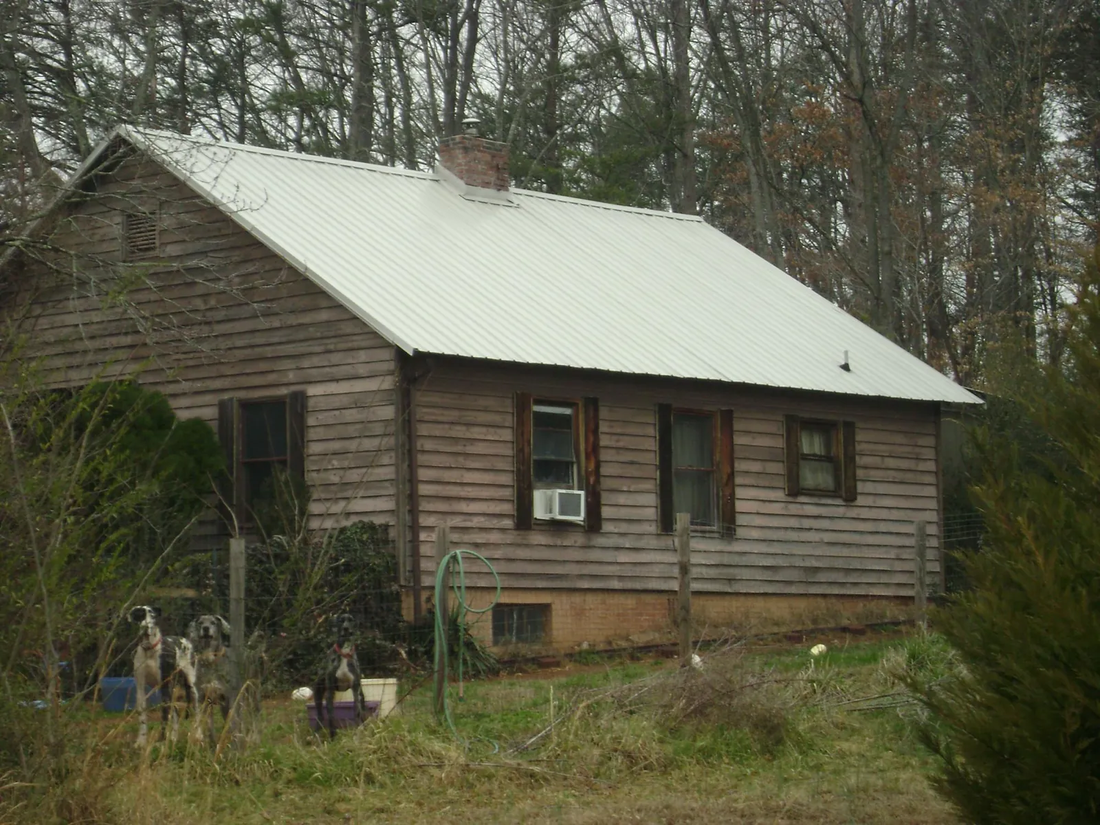 White metal roof on an old wood sided farmhouse, from a Metal Roof Installation job in Mohnton